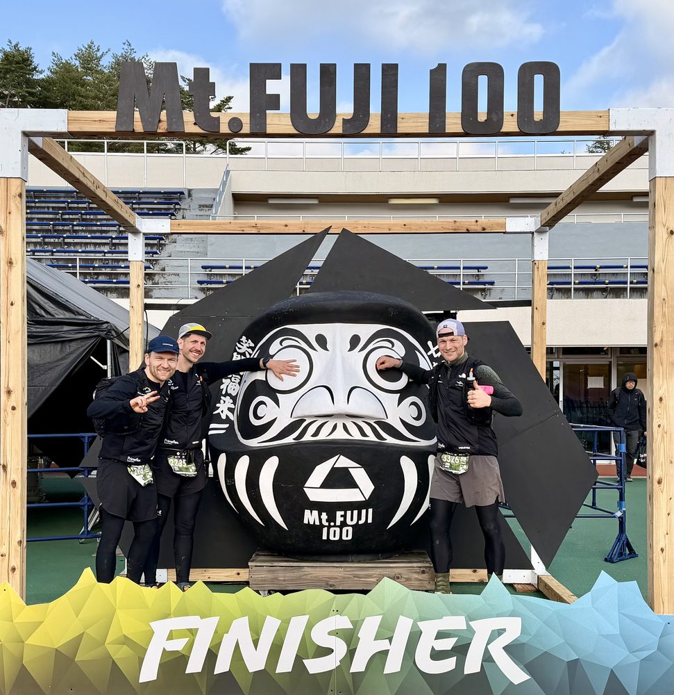 Sven and friends at the Mt Fuji 100 finisher arch with the daruma
