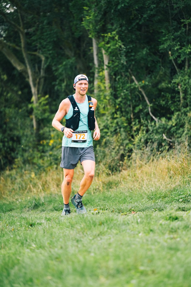 Sven running a trail in the Embrace Triple Trail Ultra wearing race bib 172